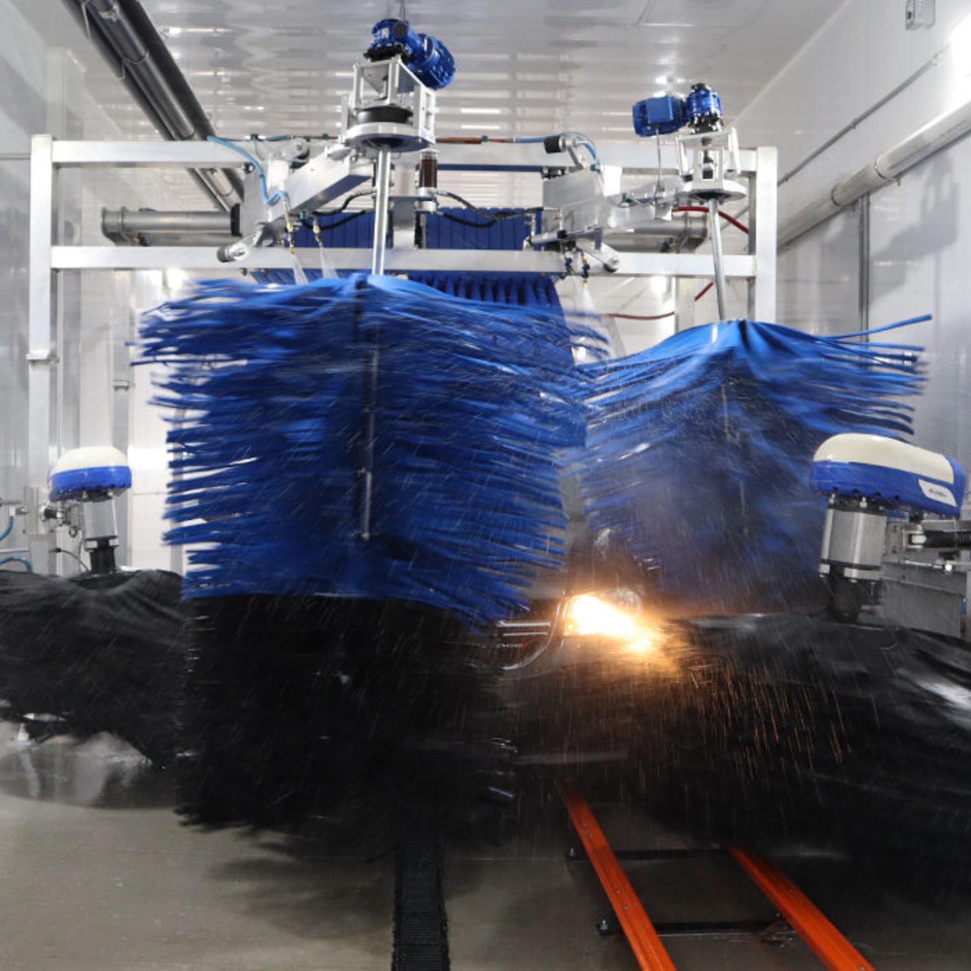 Truck moving through a fleet wash system