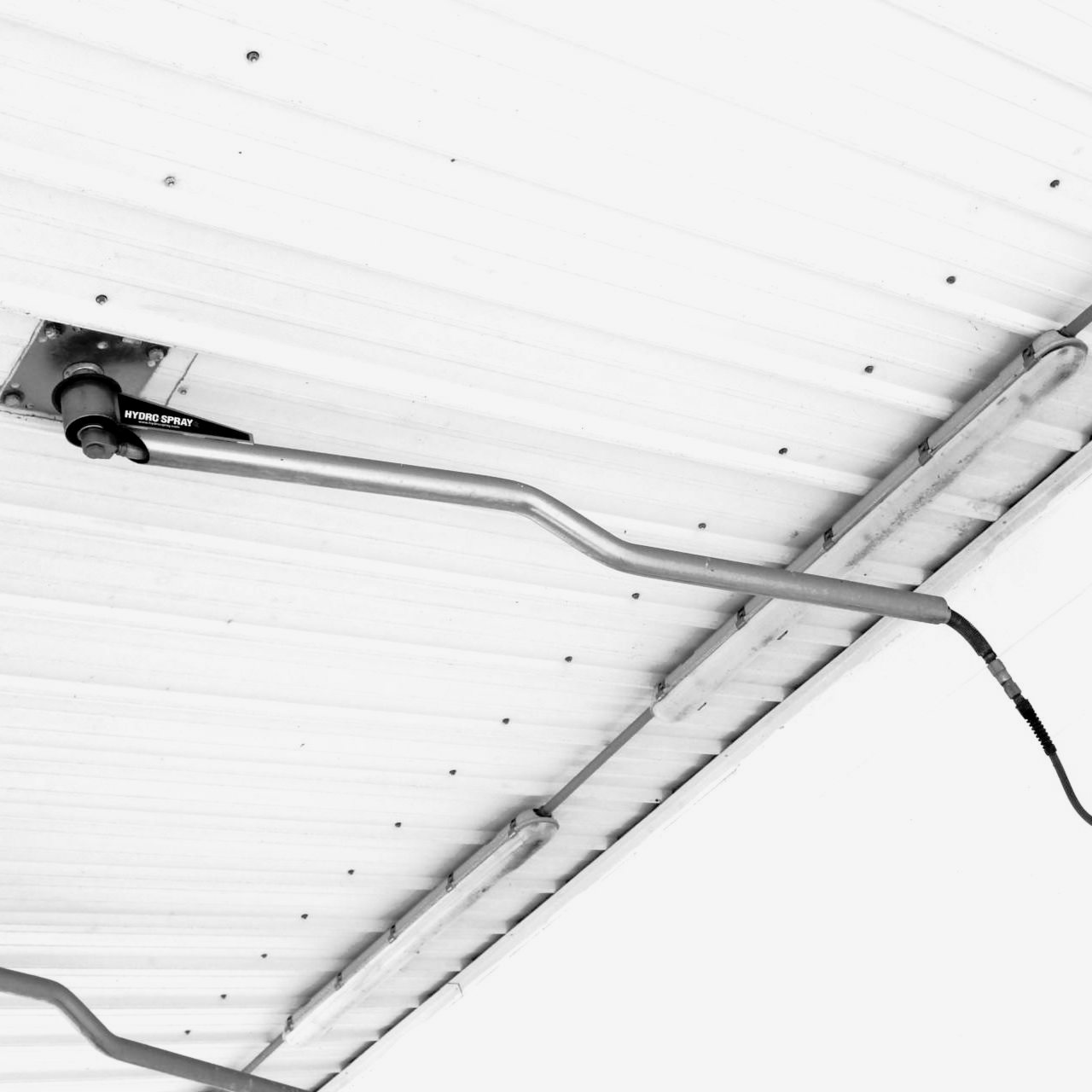 Overhead boom at a self-serve wash bay